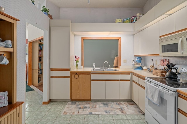 5301 Bayonne Ave, Spring Hill, FL 34608 - kitchen featuring white appliances, light countertops, white cabinetry, and light tile patterned floors