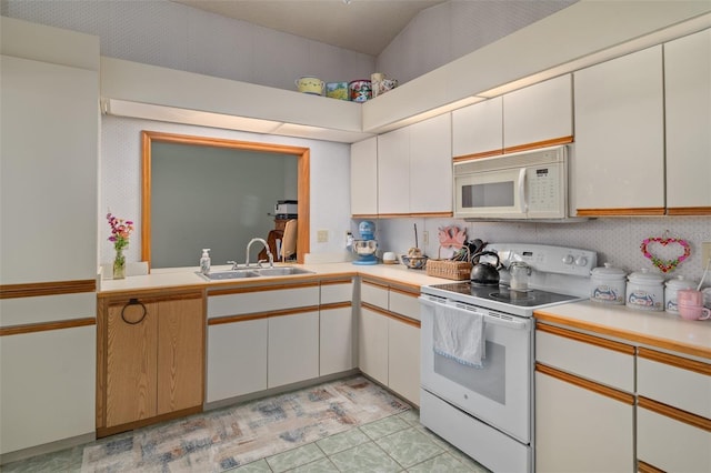 5301 Bayonne Ave, Spring Hill, FL 34608 - kitchen with white appliances, light countertops, and white cabinetry