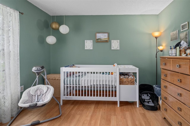 5301 Bayonne Ave, Spring Hill, FL 34608 - bedroom featuring wood finished floors and a nursery area