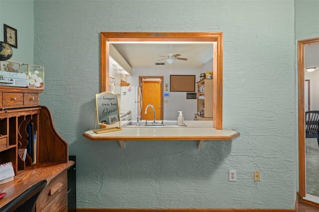 5301 Bayonne Ave, Spring Hill, FL 34608 - kitchen featuring freestanding refrigerator, ceiling fan, and a textured wall