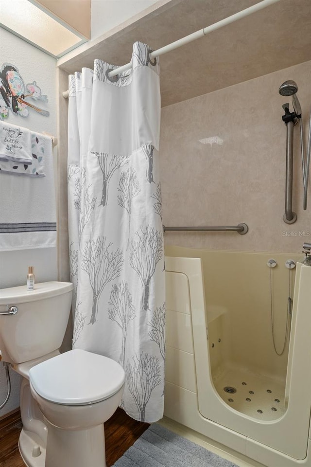 5301 Bayonne Ave, Spring Hill, FL 34608 - bathroom featuring curtained shower and wood finished floors