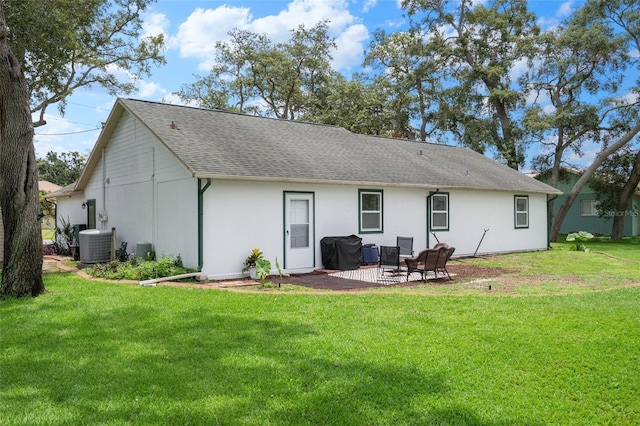5301 Bayonne Ave, Spring Hill, FL 34608 - rear view of house featuring a yard, a shingled roof, and a patio area