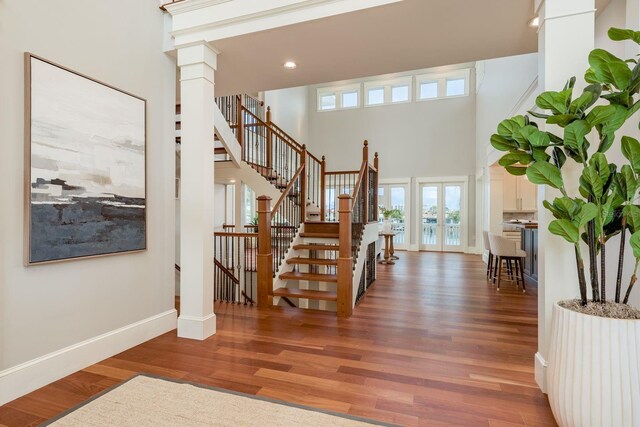 442 Midway Is, Clearwater Beach, FL 33767 - foyer featuring stairs, wood finished floors, a high ceiling, recessed lighting, and ornate columns