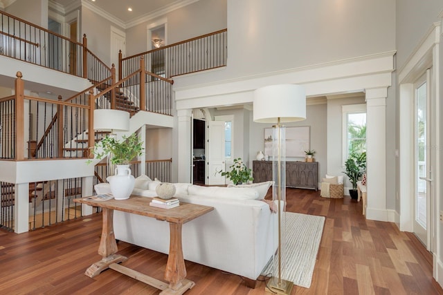 442 Midway Is, Clearwater Beach, FL 33767 - living room with ornamental molding, a towering ceiling, wood finished floors, stairway, and ornate columns