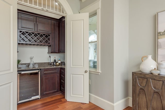 442 Midway Is, Clearwater Beach, FL 33767 - indoor wet bar featuring wine cooler and light wood finished floors