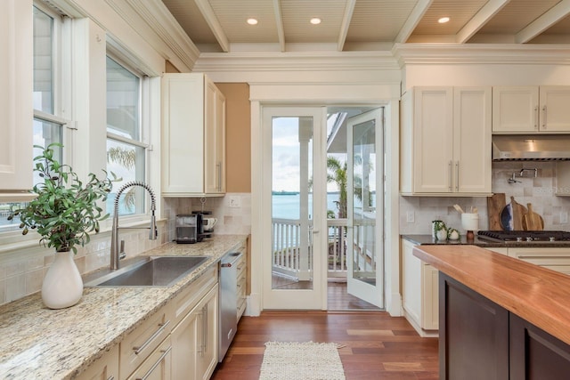 442 Midway Is, Clearwater Beach, FL 33767 - kitchen featuring under cabinet range hood, backsplash, appliances with stainless steel finishes, dark wood-type flooring, and wood counters