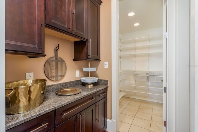 442 Midway Is, Clearwater Beach, FL 33767 - kitchen featuring light tile patterned floors, dark stone counters, recessed lighting, and dark brown cabinets