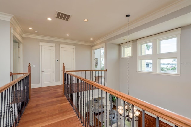 442 Midway Is, Clearwater Beach, FL 33767 - corridor featuring light wood-style flooring, an upstairs landing, ornamental molding, and recessed lighting