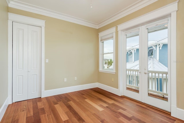 442 Midway Is, Clearwater Beach, FL 33767 - empty room with wood finished floors and ornamental molding