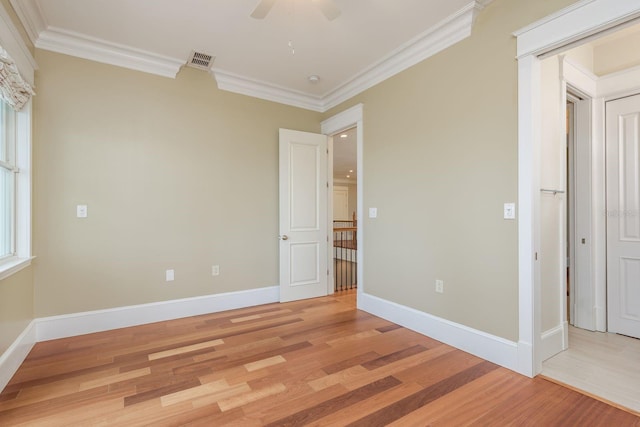 442 Midway Is, Clearwater Beach, FL 33767 - unfurnished bedroom with light wood-style floors, crown molding, and a ceiling fan