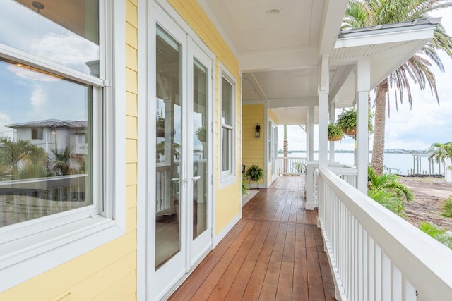 442 Midway Is, Clearwater Beach, FL 33767 - wooden terrace with a water view and french doors