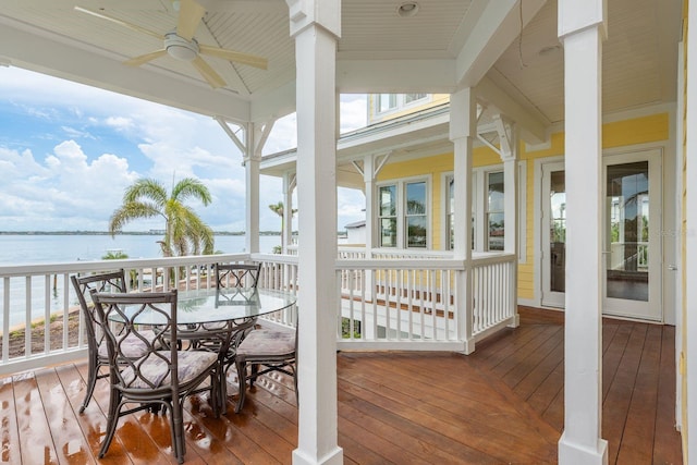 442 Midway Is, Clearwater Beach, FL 33767 - wooden terrace with a water view, ceiling fan, and outdoor dining space