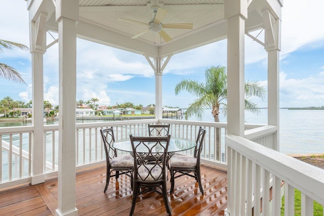 442 Midway Is, Clearwater Beach, FL 33767 - wooden deck featuring ceiling fan, a water view, and outdoor dining space