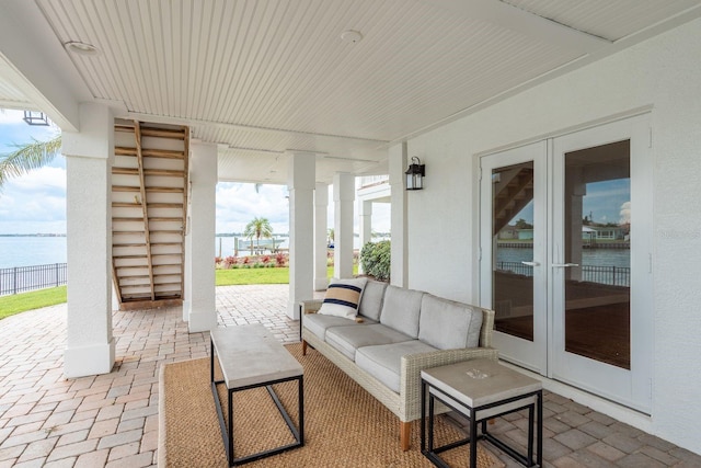 442 Midway Is, Clearwater Beach, FL 33767 - view of patio featuring french doors, a water view, and outdoor lounge area