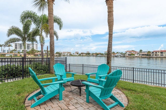 442 Midway Is, Clearwater Beach, FL 33767 - fenced backyard with an outdoor fire pit, a water view, and a patio area