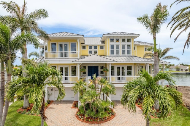 442 Midway Is, Clearwater Beach, FL 33767 - raised beach house featuring french doors, a standing seam roof, and a metal roof