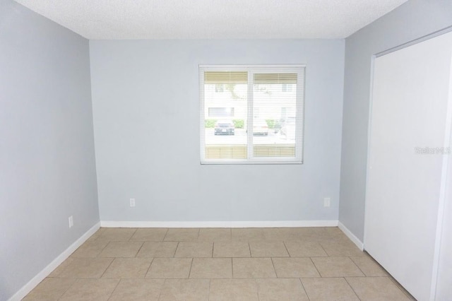 220 Berry Tree Pl Unit 220, Brandon, FL 33510 - spare room featuring a textured ceiling and light tile patterned floors