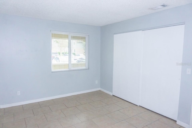 220 Berry Tree Pl Unit 220, Brandon, FL 33510 - unfurnished bedroom featuring a textured ceiling and a closet