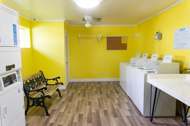 220 Berry Tree Pl Unit 220, Brandon, FL 33510 - community laundry with stacked washing machine and dryer, ornamental molding, light wood finished floors, and independent washer and dryer
