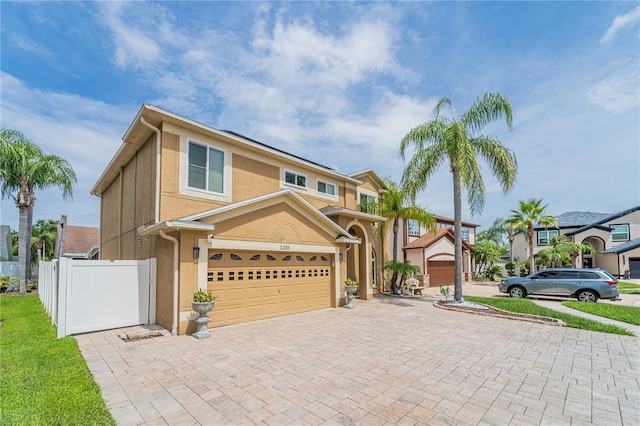 1205 Sweet Gum Dr, Brandon, FL 33511 - view of front of home featuring decorative driveway, a garage, and stucco siding