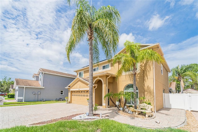 1205 Sweet Gum Dr, Brandon, FL 33511 - mediterranean / spanish-style house featuring a gate, driveway, stucco siding, and an attached garage