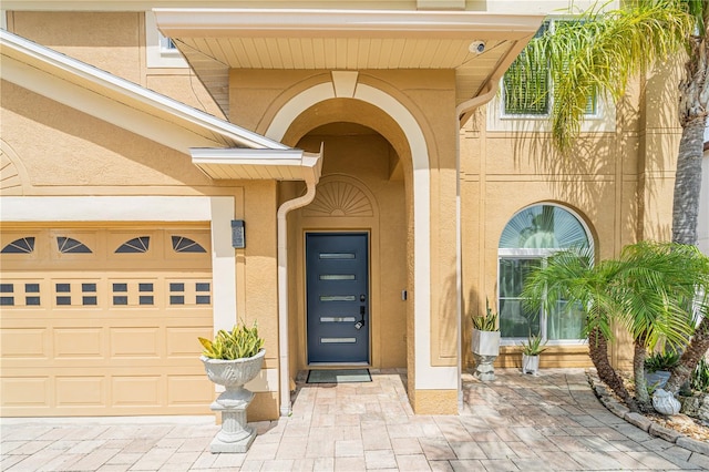1205 Sweet Gum Dr, Brandon, FL 33511 - entrance to property with stucco siding, driveway, and a security system