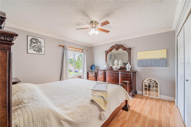 1205 Sweet Gum Dr, Brandon, FL 33511 - bedroom with light wood finished floors, a closet, crown molding, a ceiling fan, and a textured ceiling
