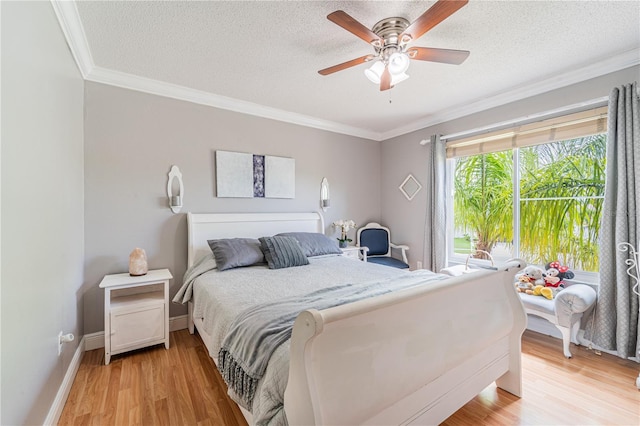 1205 Sweet Gum Dr, Brandon, FL 33511 - bedroom with crown molding, light wood-style flooring, a textured ceiling, and ceiling fan