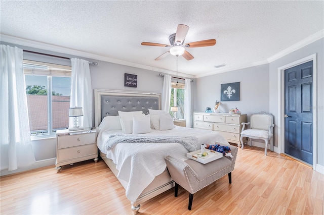 1205 Sweet Gum Dr, Brandon, FL 33511 - bedroom featuring ornamental molding, light wood-style flooring, a textured ceiling, and a ceiling fan