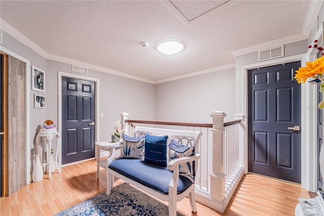 1205 Sweet Gum Dr, Brandon, FL 33511 - entryway with light wood-style flooring, a textured ceiling, and ornamental molding