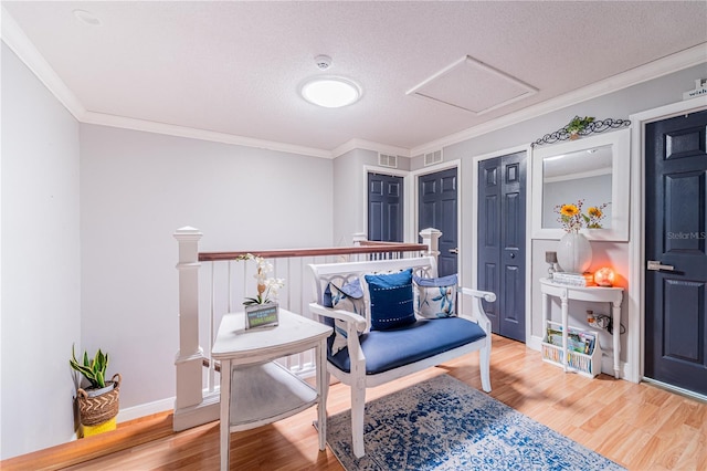 1205 Sweet Gum Dr, Brandon, FL 33511 - sitting room featuring wood finished floors, ornamental molding, attic access, and a textured ceiling