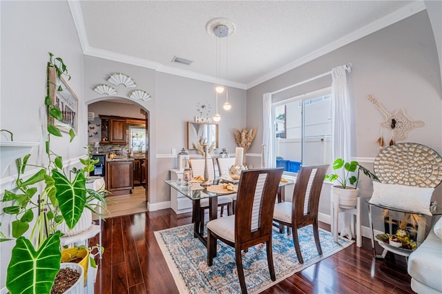 1205 Sweet Gum Dr, Brandon, FL 33511 - dining space with arched walkways, dark wood-style floors, and ornamental molding
