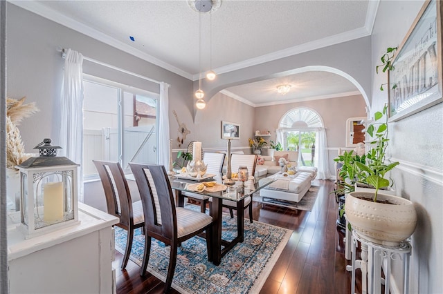 1205 Sweet Gum Dr, Brandon, FL 33511 - dining space with arched walkways, dark wood finished floors, crown molding, and a textured ceiling