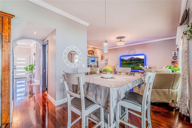 1205 Sweet Gum Dr, Brandon, FL 33511 - dining room with arched walkways, crown molding, dark wood finished floors, and a textured ceiling
