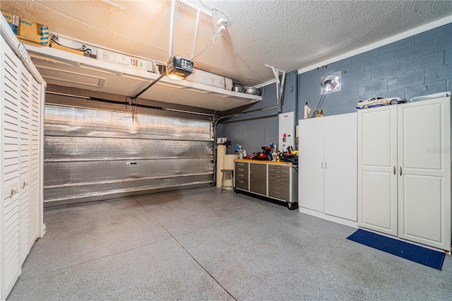 1205 Sweet Gum Dr, Brandon, FL 33511 - garage featuring concrete block wall, a garage door opener, and a workshop area