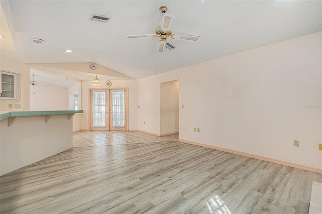 4355 Odin St, Spring Hill, FL 34608 - unfurnished living room featuring a ceiling fan, light wood-type flooring, lofted ceiling, recessed lighting, and french doors