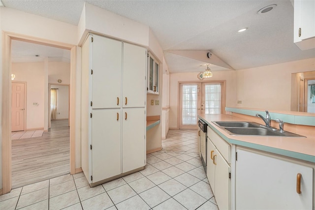 4355 Odin St, Spring Hill, FL 34608 - kitchen with lofted ceiling, light tile patterned flooring, light countertops, a textured ceiling, and white cabinetry