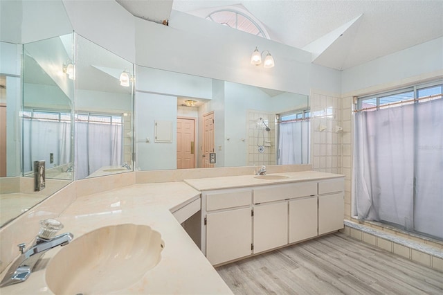 4355 Odin St, Spring Hill, FL 34608 - bathroom with wood finished floors, a stall shower, double vanity, and lofted ceiling