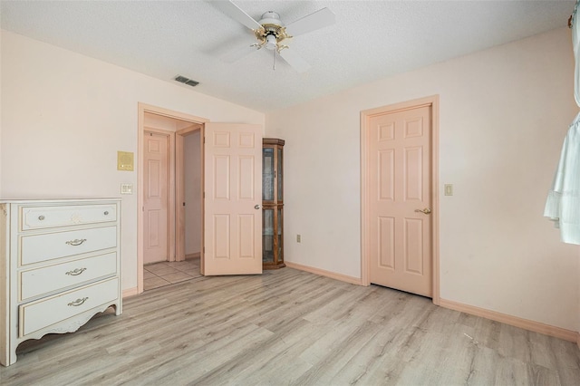 4355 Odin St, Spring Hill, FL 34608 - unfurnished bedroom with light wood-type flooring, ceiling fan, and a textured ceiling
