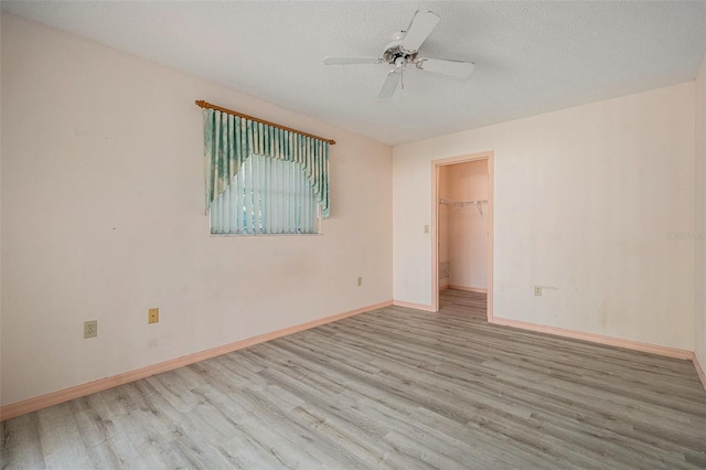 4355 Odin St, Spring Hill, FL 34608 - empty room with wood finished floors, ceiling fan, and a textured ceiling