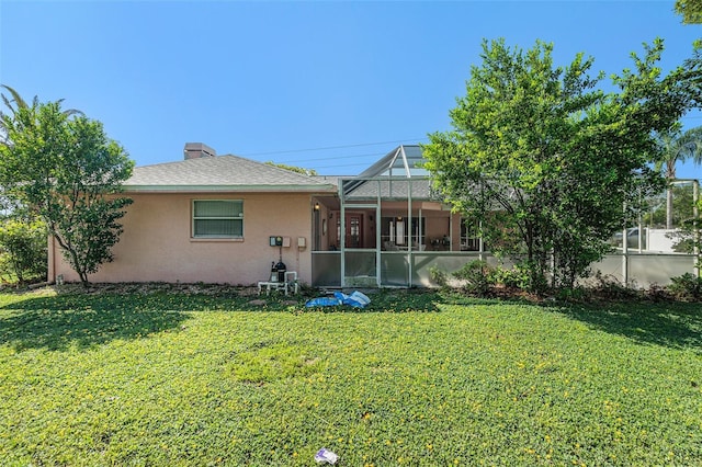 4355 Odin St, Spring Hill, FL 34608 - back of property with a yard, stucco siding, a lanai, and a chimney
