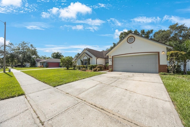 12405 Pathway Ct, Riverview, FL 33569 - view of front of property featuring concrete driveway, a front yard, a garage, and brick siding