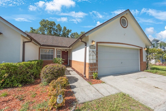 12405 Pathway Ct, Riverview, FL 33569 - ranch-style house featuring an attached garage, brick siding, driveway, and stucco siding