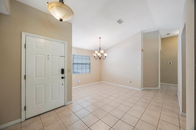 12405 Pathway Ct, Riverview, FL 33569 - entrance foyer featuring a chandelier, light tile patterned floors, and vaulted ceiling