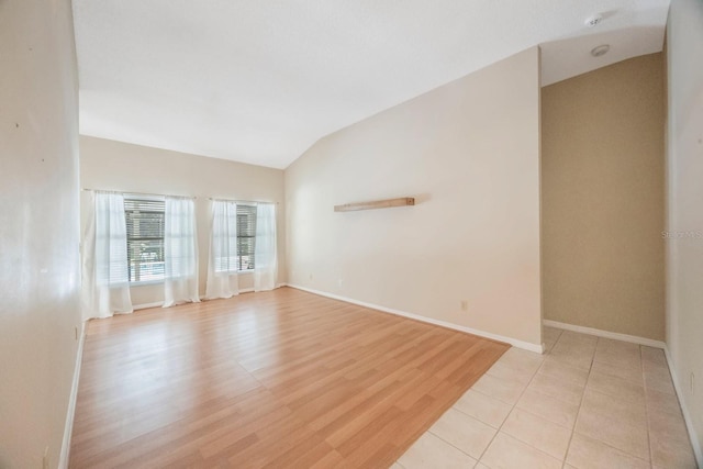 12405 Pathway Ct, Riverview, FL 33569 - spare room with lofted ceiling, light wood-style floors, and a smoke detector