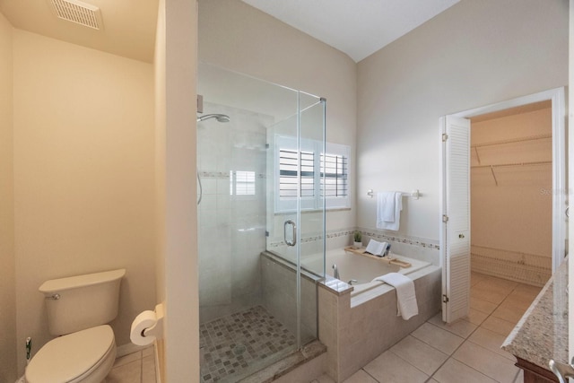12405 Pathway Ct, Riverview, FL 33569 - full bathroom with a bath, a stall shower, a spacious closet, and tile patterned floors