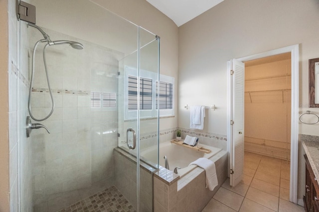 12405 Pathway Ct, Riverview, FL 33569 - full bath featuring a stall shower, a garden tub, tile patterned floors, vanity, and a spacious closet