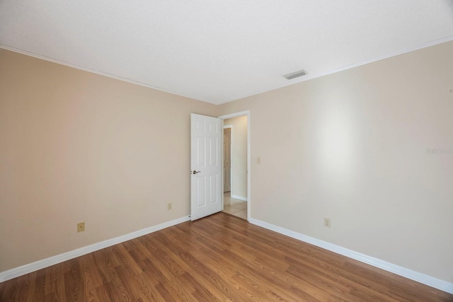12405 Pathway Ct, Riverview, FL 33569 - spare room with light wood finished floors and ornamental molding