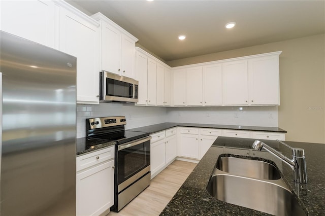 5909 Bibb Ct, North Port, FL 34288 - kitchen with appliances with stainless steel finishes, white cabinetry, backsplash, and recessed lighting