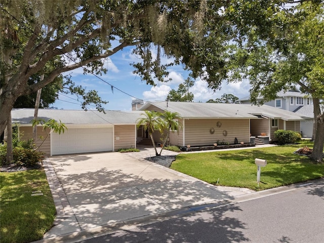 17 Freshwater Dr, Palm Harbor, FL 34684 - view of front of house with a front lawn and a detached garage